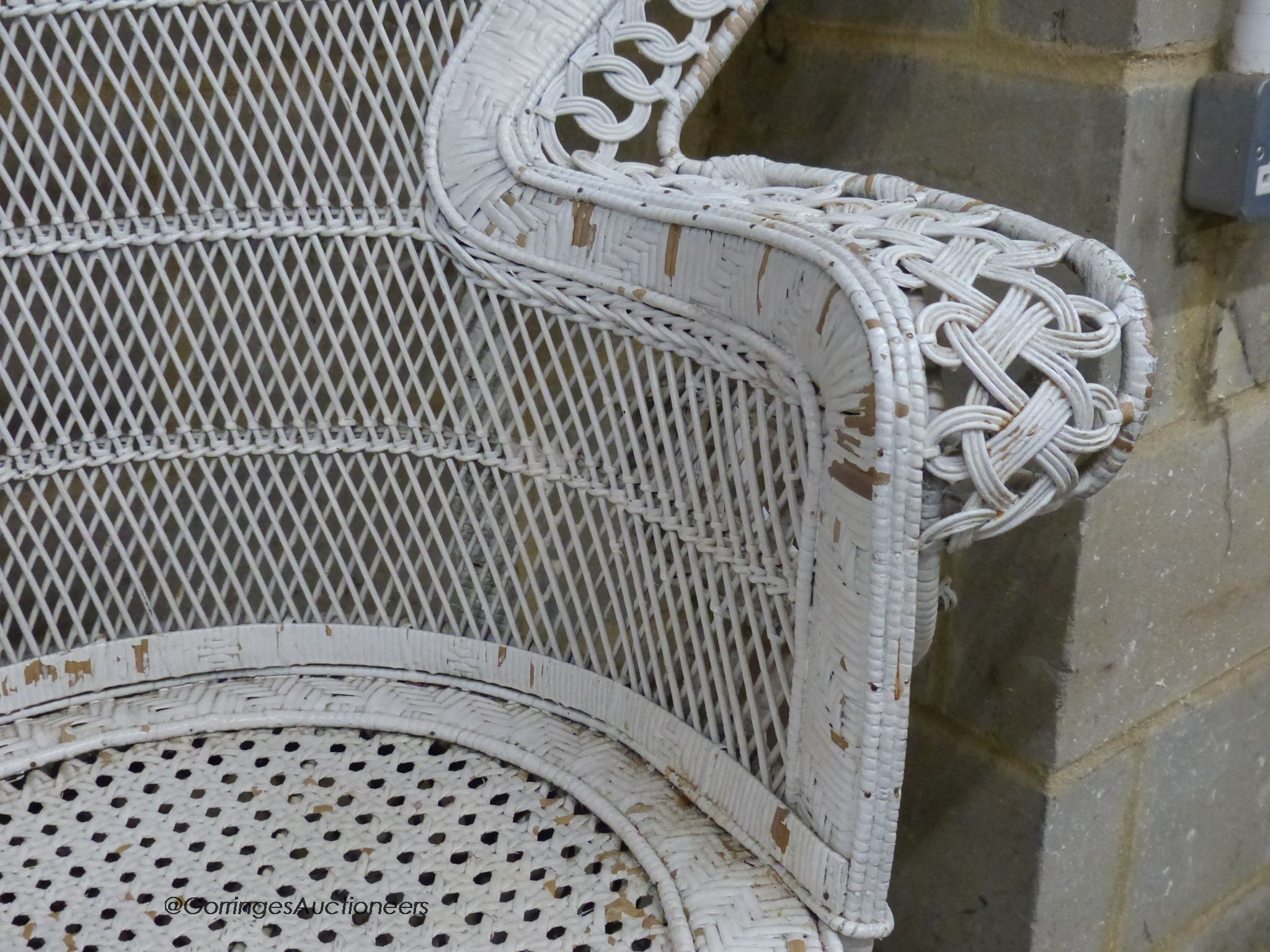 A white painted wickerwork peacock armchair, width 110cm, height 146cm